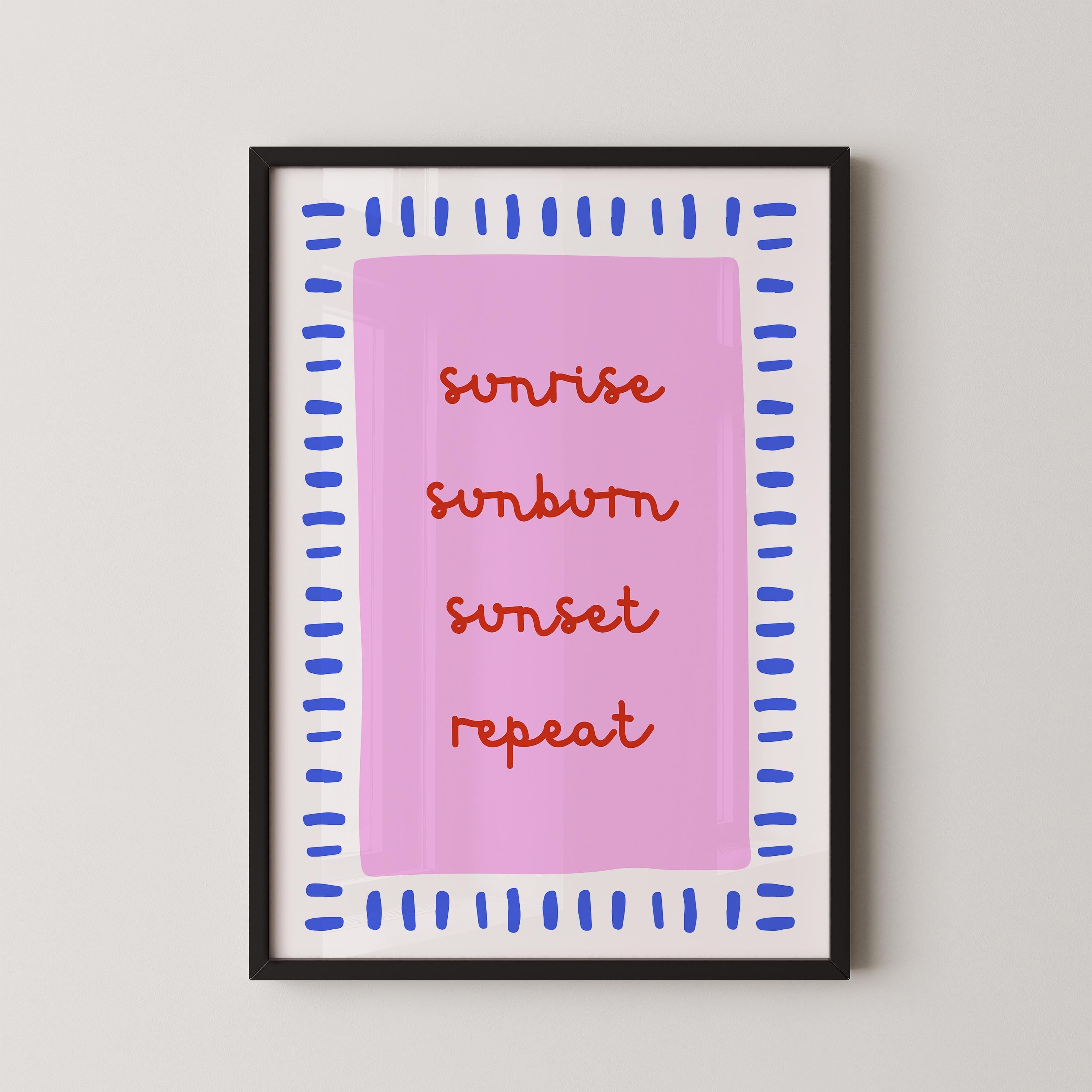 a framed poster with the text "sunrise, sunburn, sunset, repeat" written in a stylized font on a pink background.