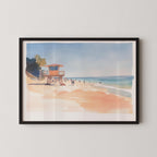 A framed watercolor painting depicting a beach scene with a lifeguard tower, people walking along the shore, and a clear blue sky.
