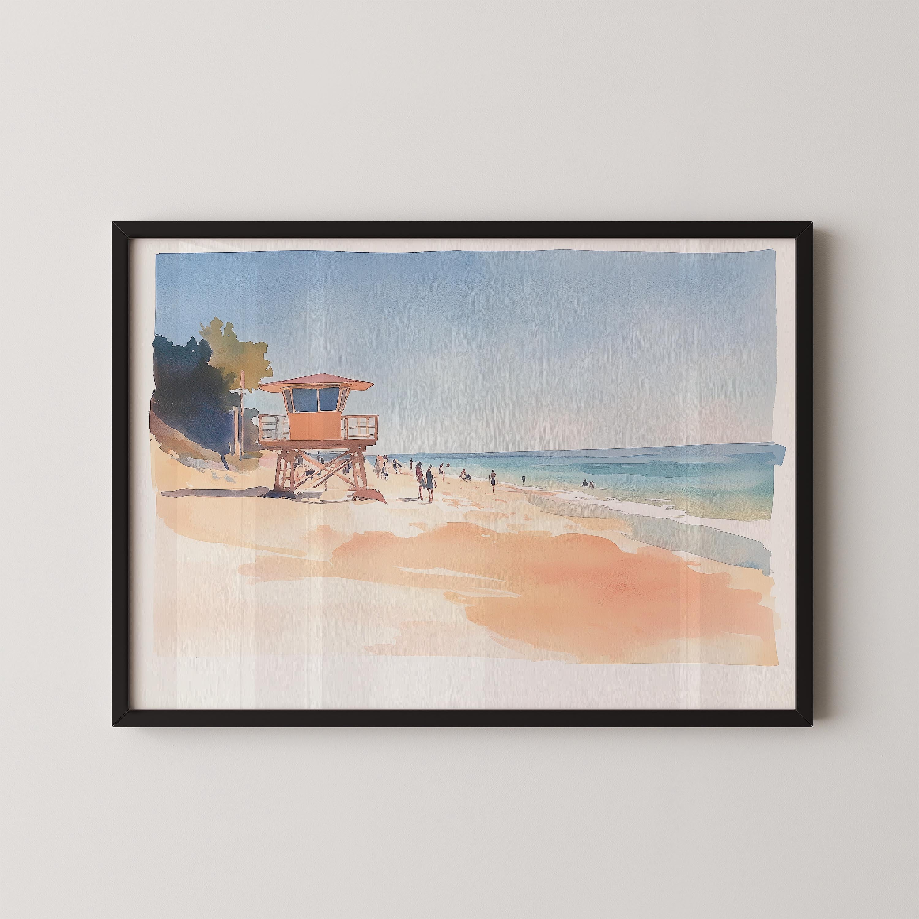 A framed watercolor painting depicting a beach scene with a lifeguard tower, people walking along the shore, and a clear blue sky.