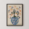A framed illustration of a vase filled with pink and white flowers, with blue and green accents, set against a light background.