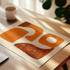 a close-up view of a piece of paper with a large, abstract design on it, placed on a wooden surface.