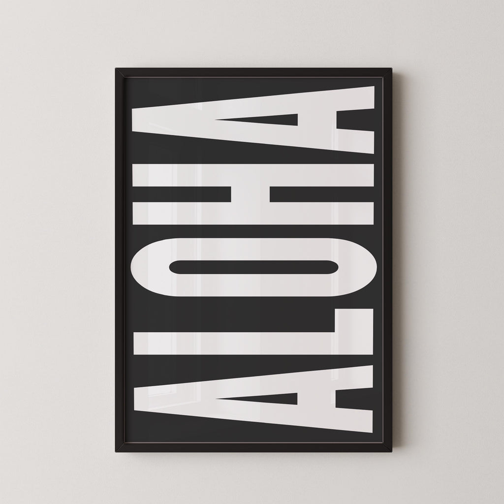 a framed poster with the word "ALOHA" prominently displayed in large white letters.