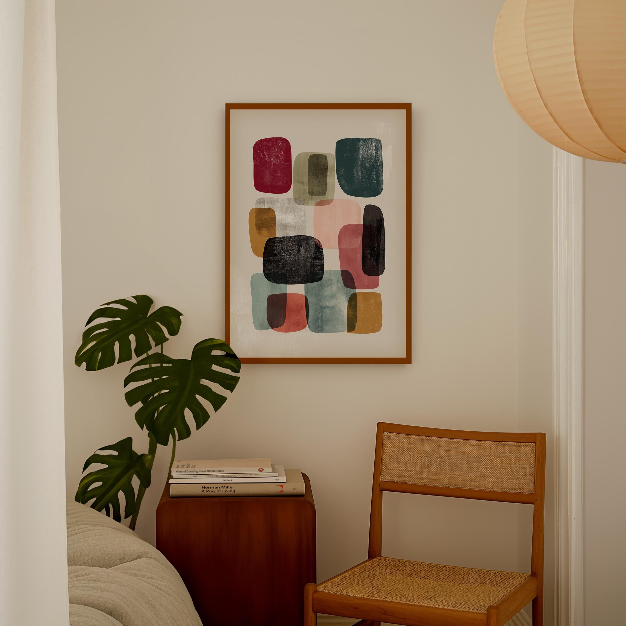 a cozy corner of a room with a framed abstract art piece hanging on the wall, a wooden chair, a small table with books, and a large monstera plant.