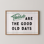 a framed poster with the text "These are the good old days" in a simple, bold font.