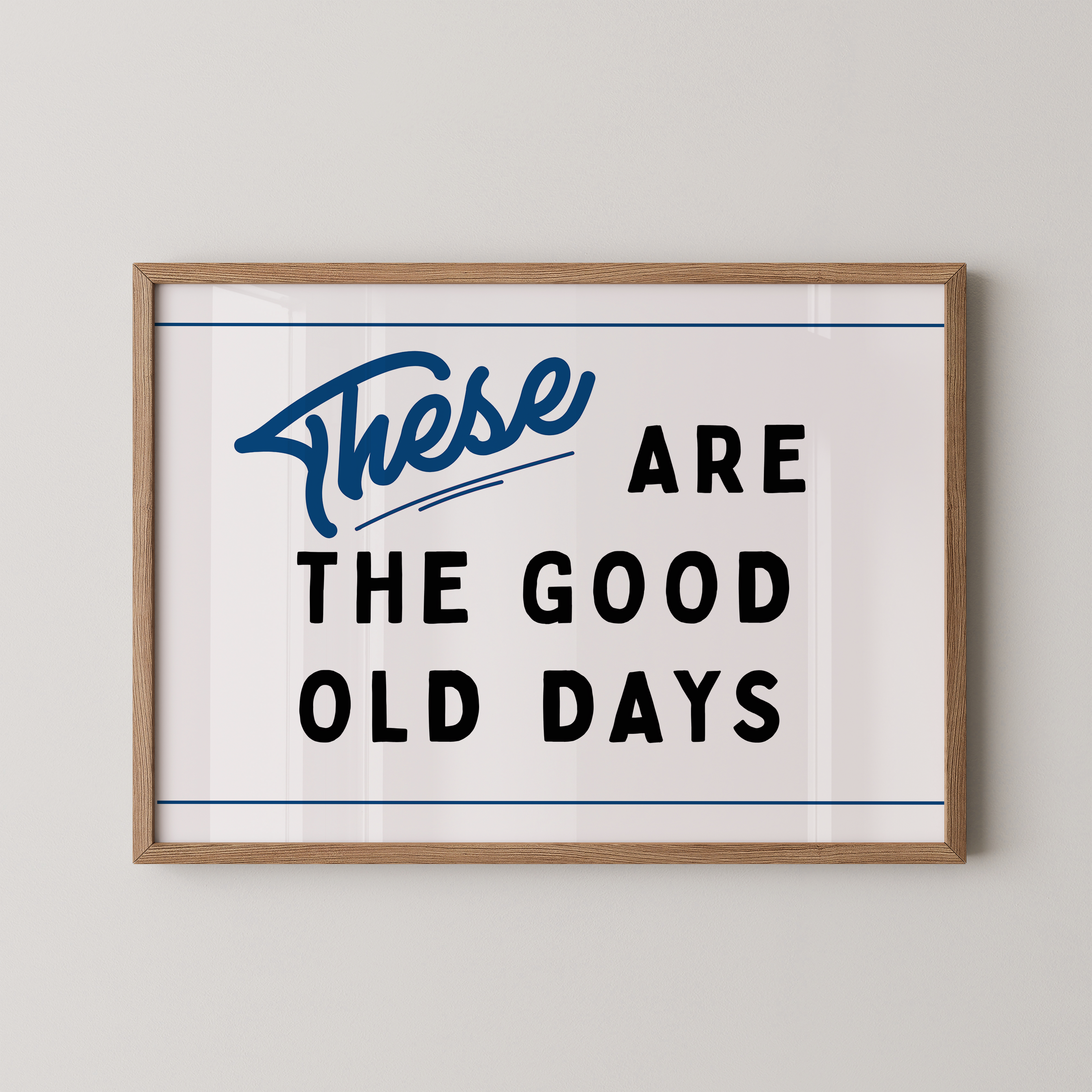 a framed poster with the text "These are the good old days" in a blue and black color scheme.