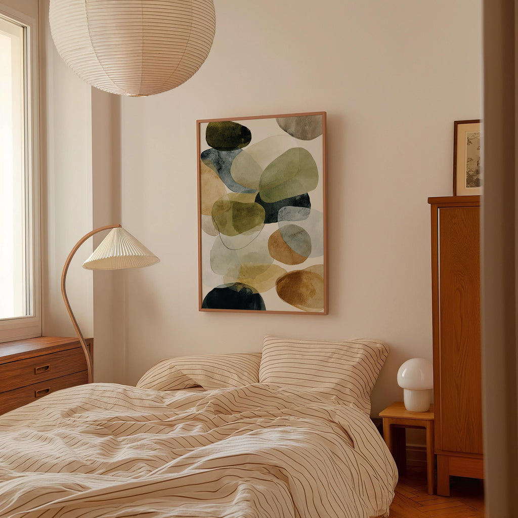 a cozy bedroom with a large bed, a wooden dresser, and a lamp. The room has a minimalist and modern design, with a large abstract painting hanging on the wall above the bed.