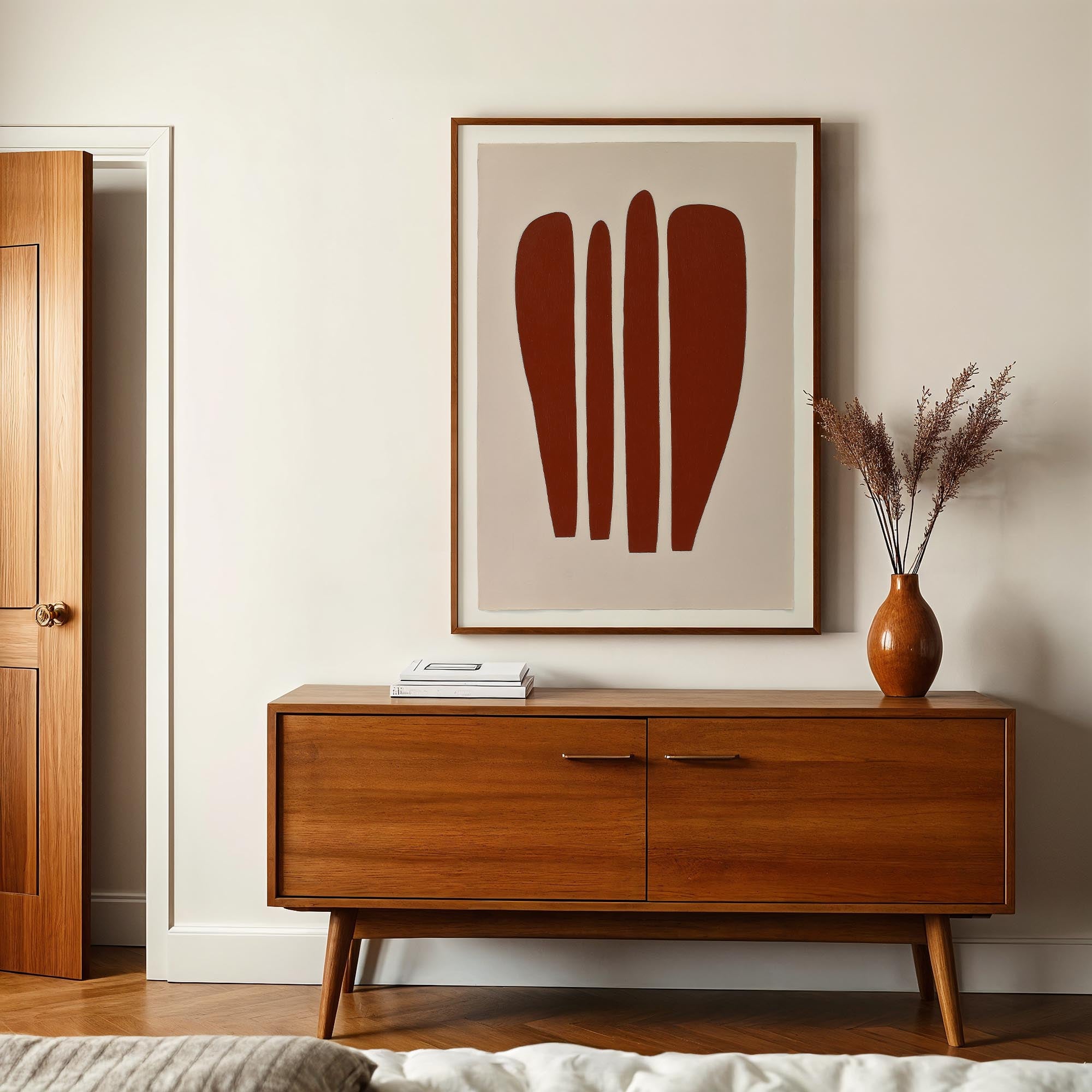 a modern interior design with a wooden cabinet, a framed abstract artwork, and a vase with dried flowers on a table.