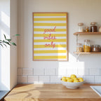 a kitchen counter with a bowl of lemons, a framed poster with the text "good vibes only", and shelves displaying various jars and containers.