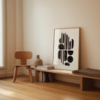 a minimalist interior design with a wooden chair, a wooden bench, a framed abstract artwork, and a stack of books on a shelf.