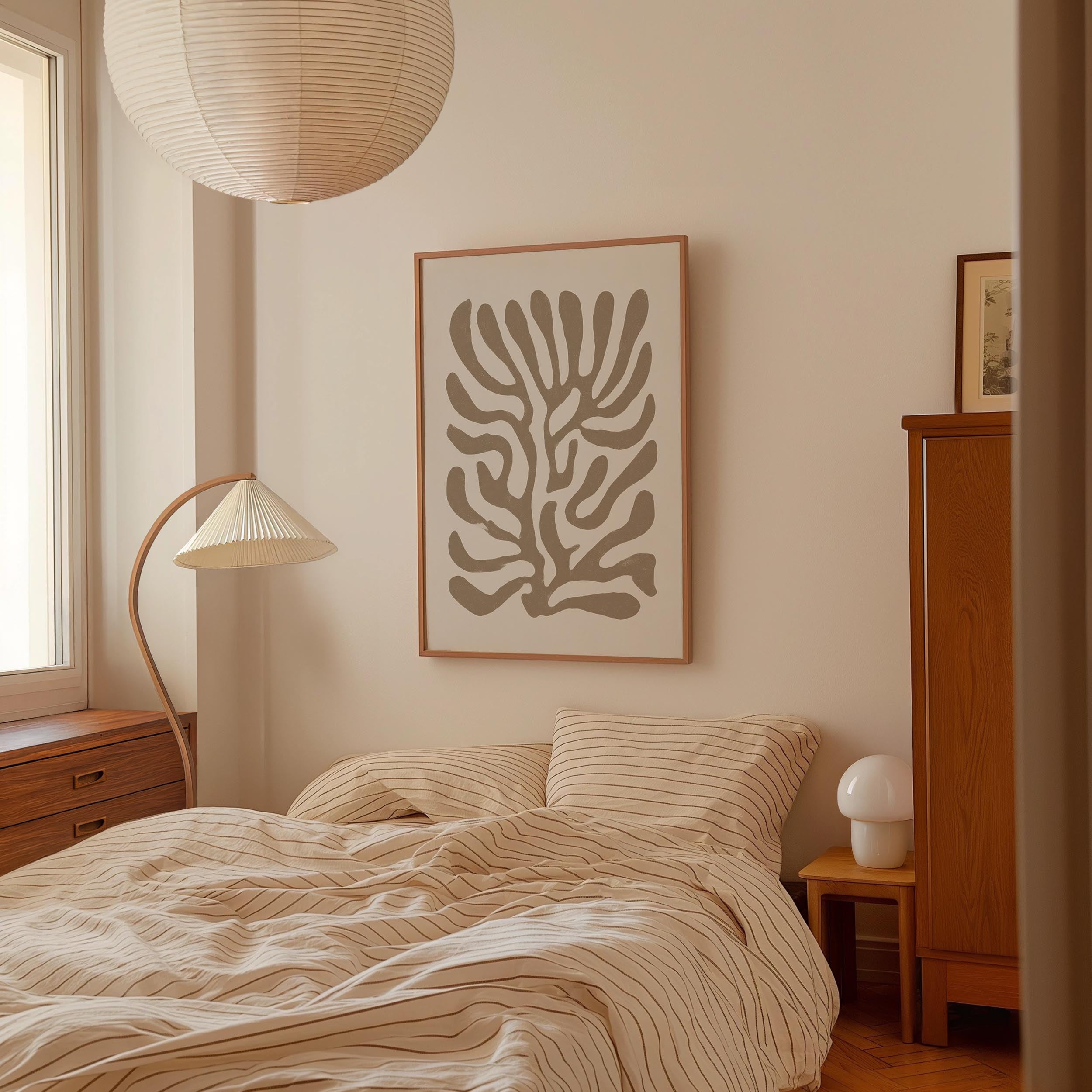 a cozy bedroom with a large bed, a lamp, and a framed abstract art piece on the wall.