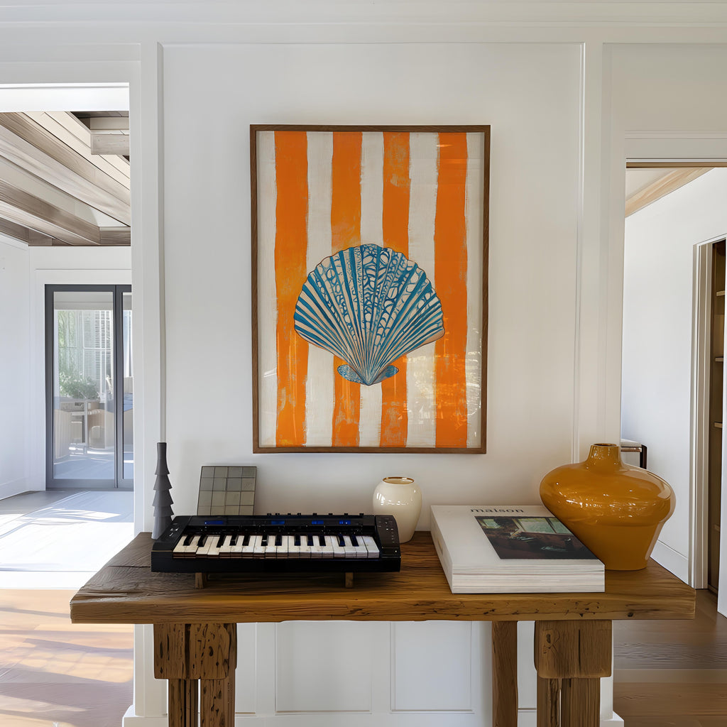 a wooden table with a keyboard, a vase, and a framed picture of a seashell on the wall above it.