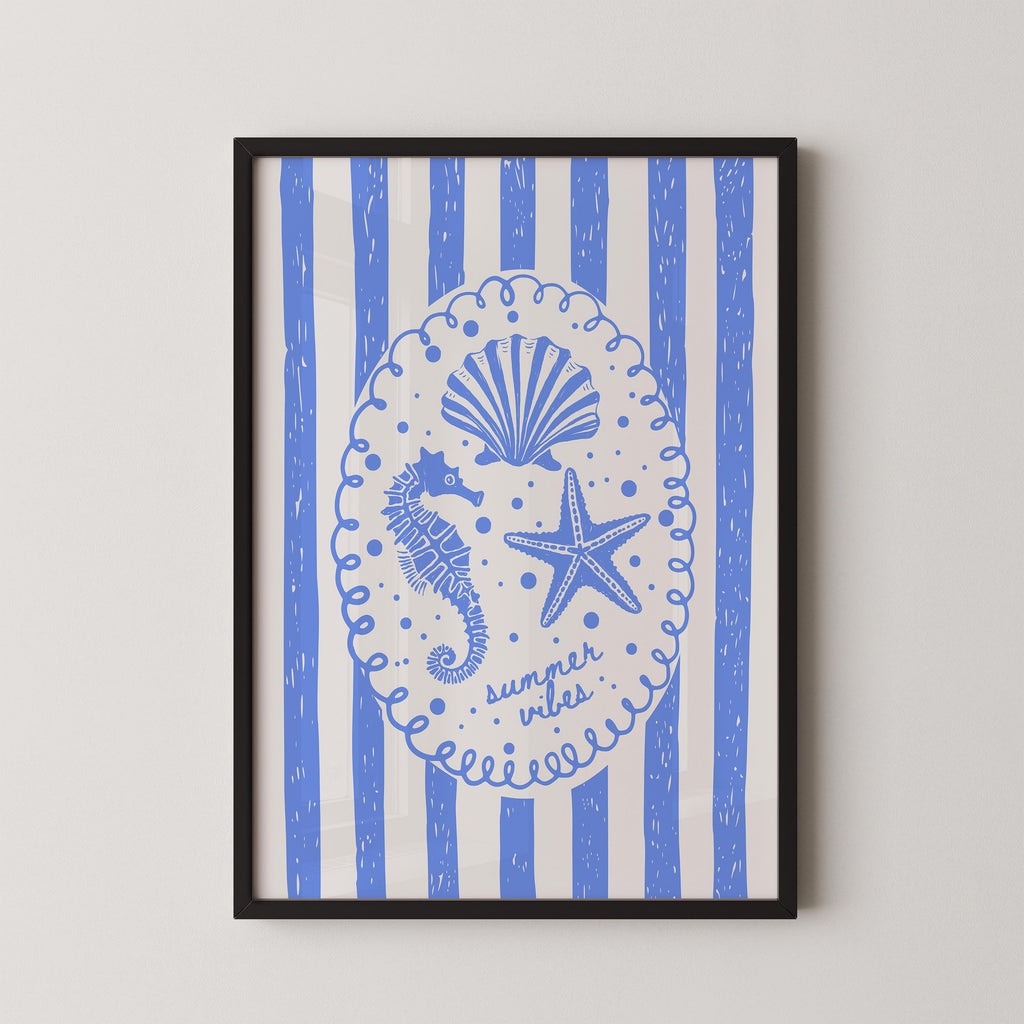 The image is a framed print featuring a blue and white design with a central illustration of a seahorse, starfish, and seashell, surrounded by blue and white striped patterns.