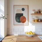 a kitchen counter with a bowl of lemons, a framed abstract art piece, and shelves displaying various jars and containers.