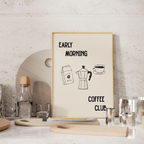 a framed poster with the text "Early Morning Coffee Club" and illustrations of coffee-making equipment, such as a coffee maker and a coffee cup.