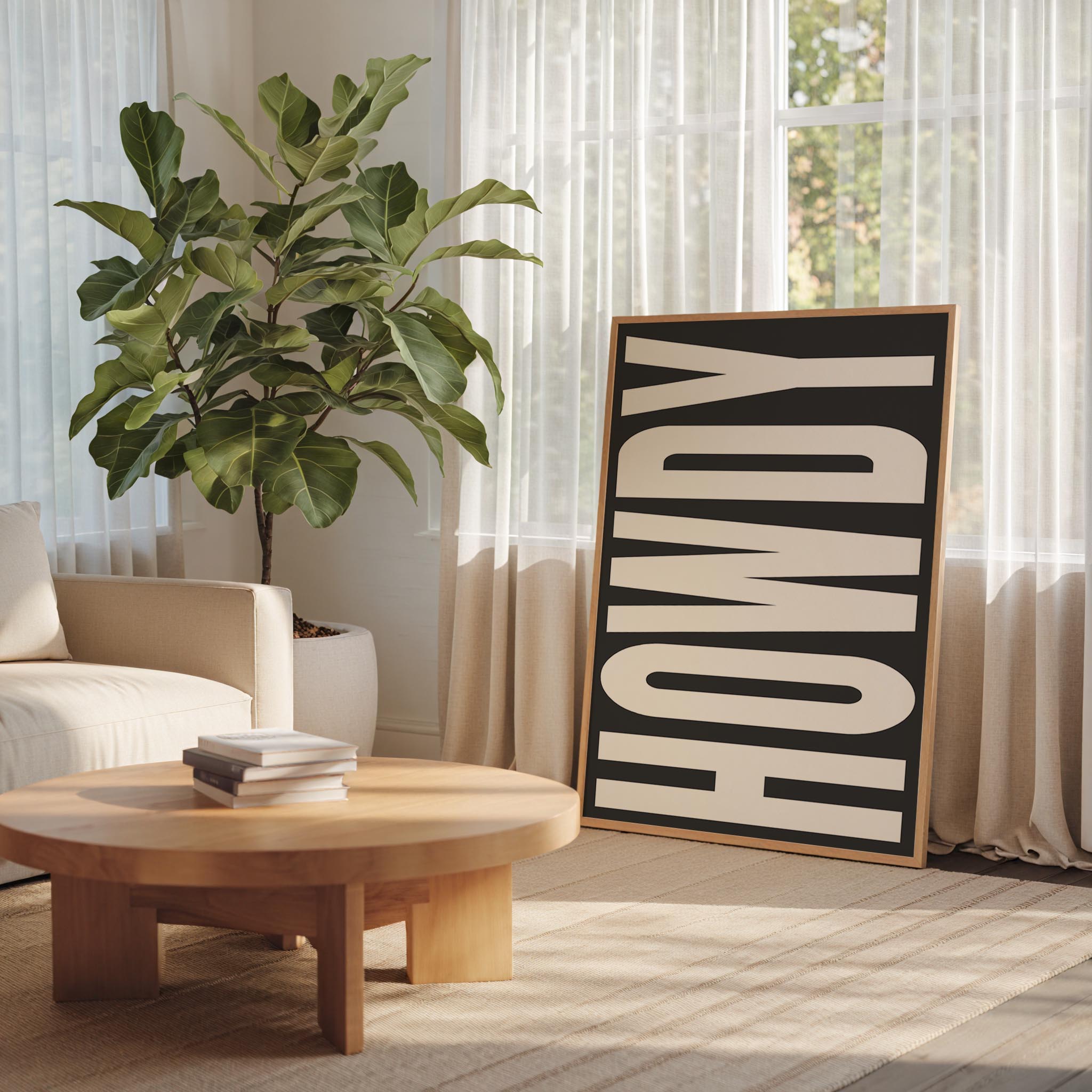 a living room with a large potted plant, a wooden coffee table, and a framed sign with the word "HOWDY" on it.