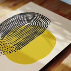 a close-up view of a piece of art with a striking abstract design. The artwork is predominantly composed of black and yellow lines and dots, creating a visually striking contrast. The composition is simple yet captivating, with the lines and dots arranged in a way that draws the viewer's attention to the central element.