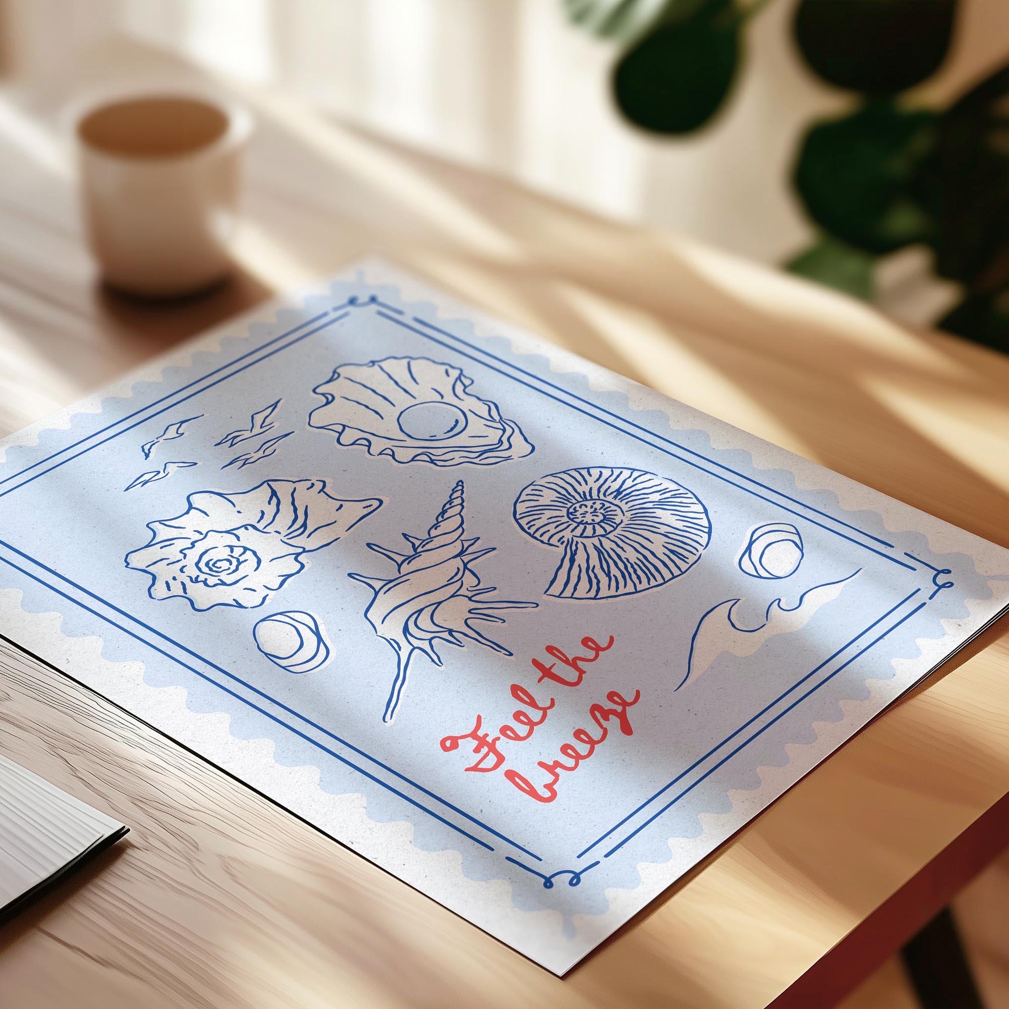 A blue and white paper with illustrations of seashells and a message that says "Feel the breeze" written on it, placed on a wooden surface.