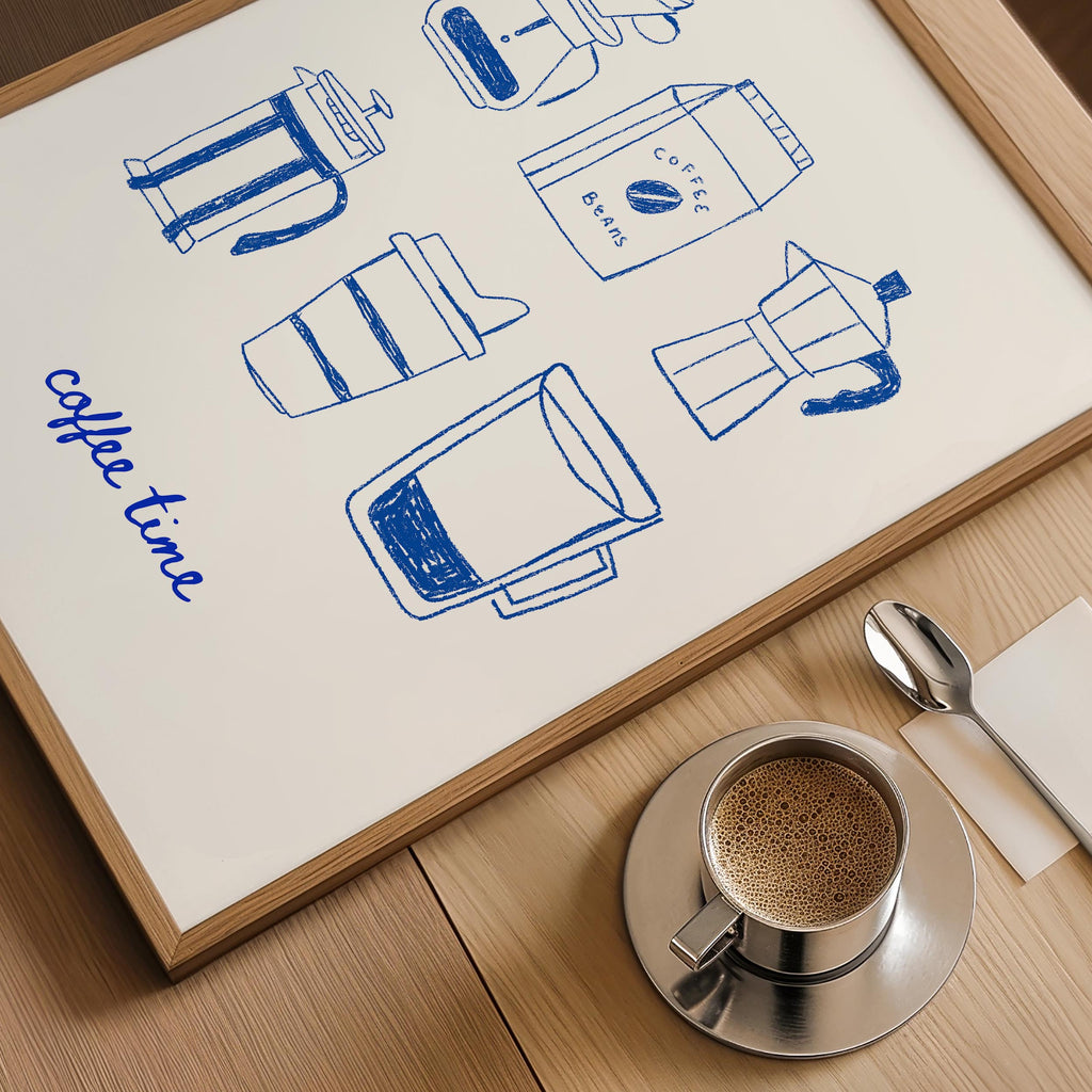 a framed poster with illustrations of coffee-making equipment, including a French press, coffee beans, and a coffee cup, along with the phrase "coffee time" written on the poster. Next to the poster is a cup of coffee and a spoon, suggesting a cozy coffee-drinking setting.