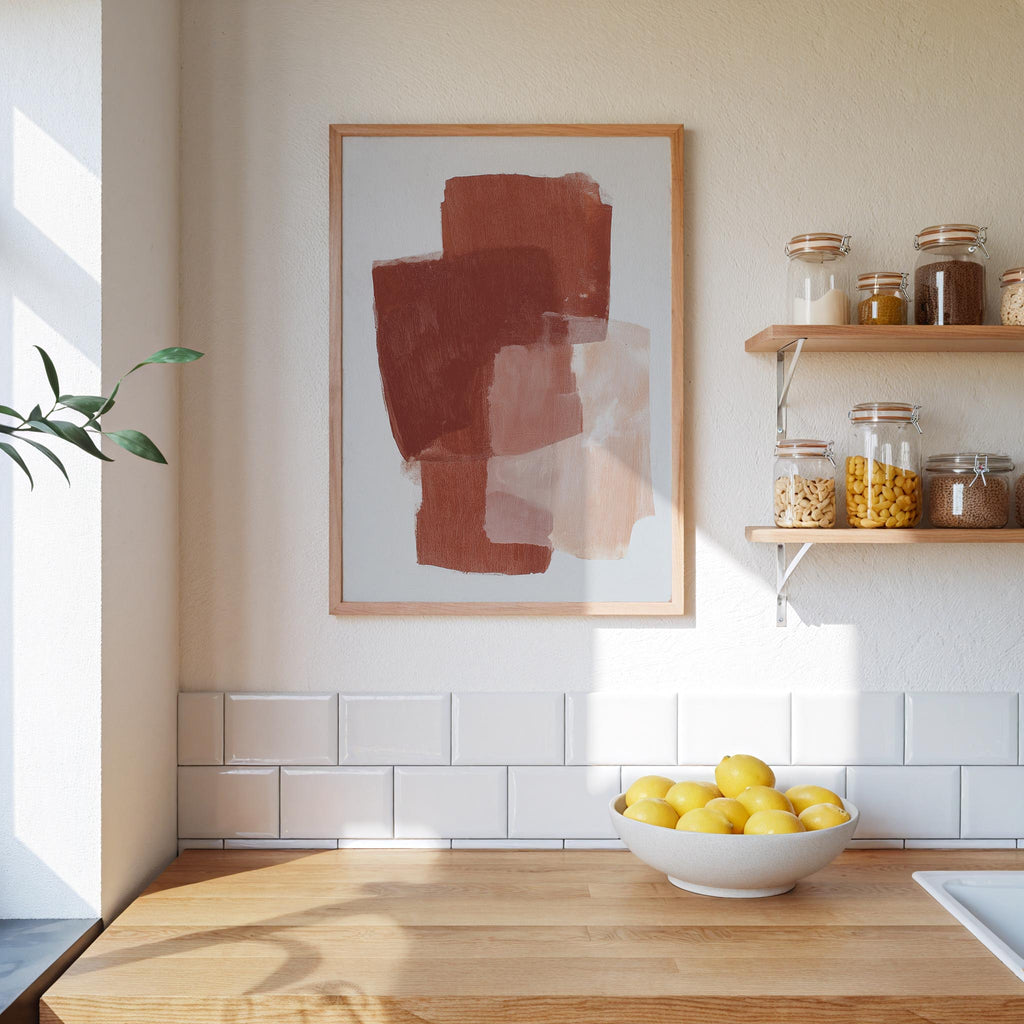 a kitchen counter with a bowl of lemons, a framed abstract painting on the wall, and shelves displaying various jars and containers.