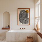 a modern bathroom with a large white bathtub, a wooden shelf, and a framed abstract artwork on the wall.