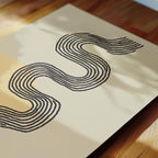 a close-up view of a piece of paper with a black line drawing of a snake-like shape on it.