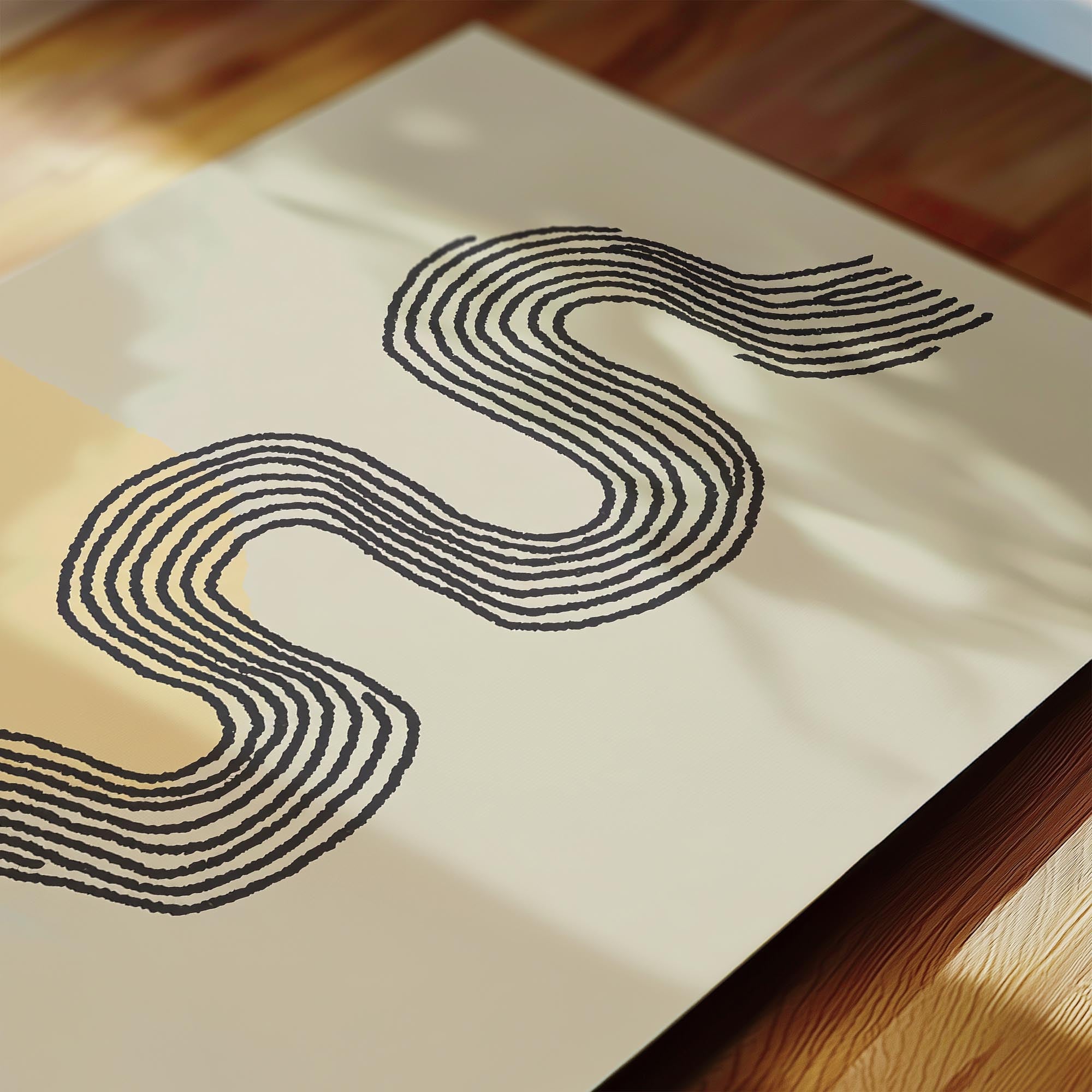 a close-up view of a piece of paper with a black line drawing of a snake-like shape on it.
